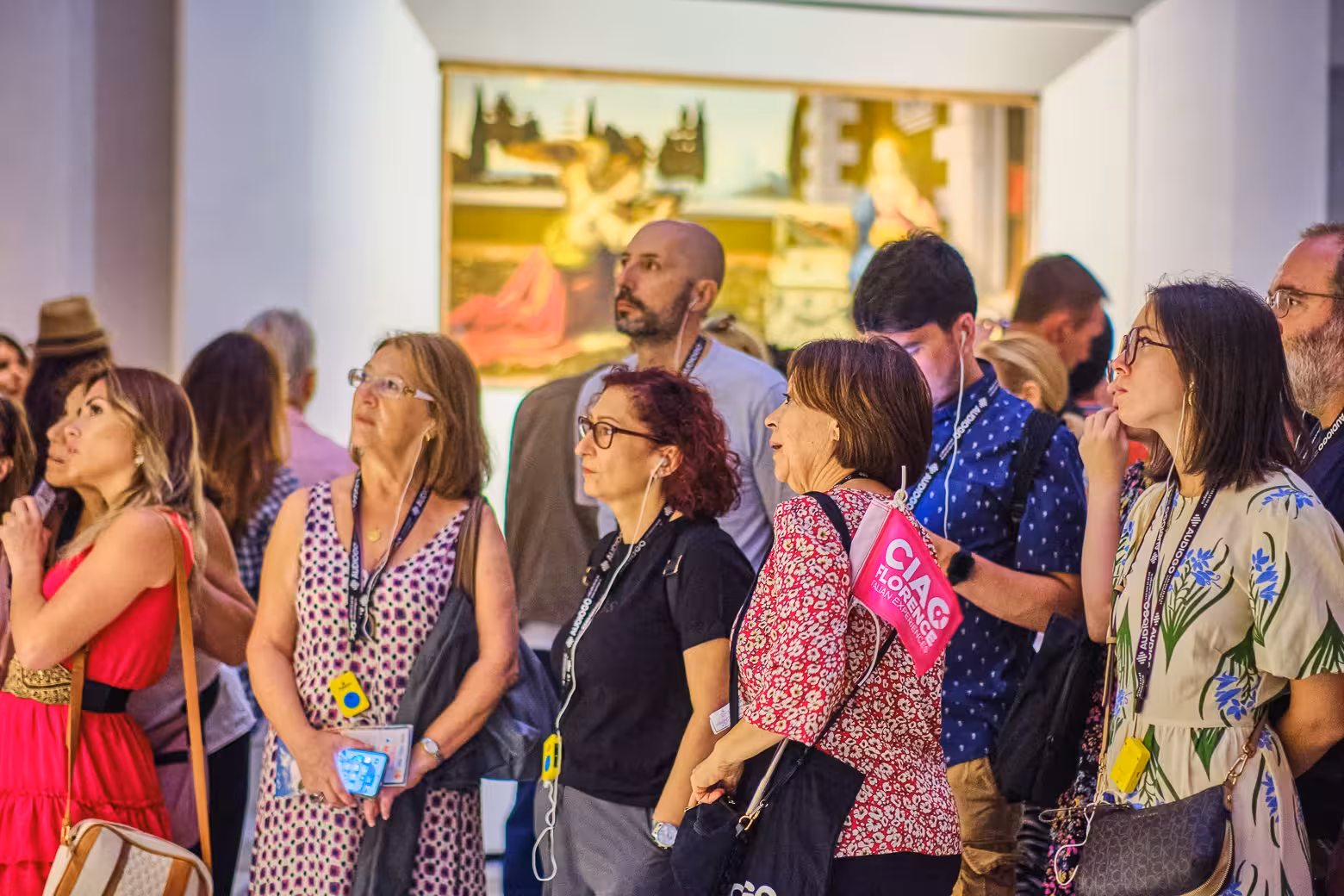 Enthralled tourists enjoy detailed explanations on Uffizi Gallery and Vasari Corridor small group guided tour.