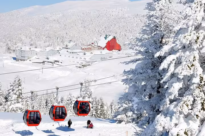 Uludag cable car cabins over snowy Bursa resort, winter day trip from Istanbul with lunch option