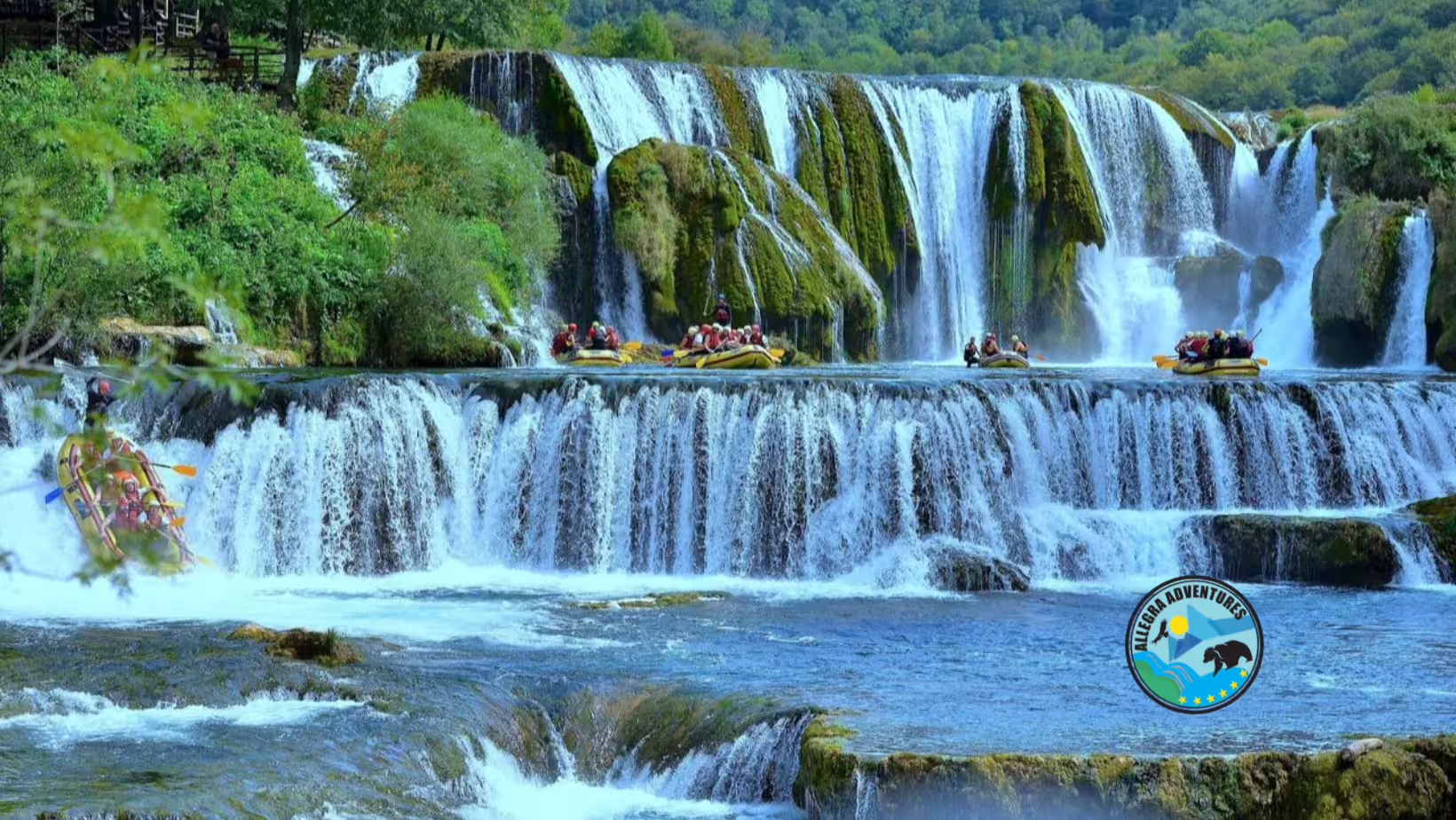 Rafts cruising below Štrbački Buk waterfall on the Una River, a day trip rafting adventure from Plitvice Lakes