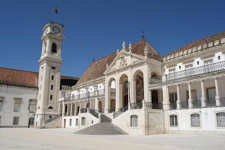 The grand courtyard and clock tower of the University of Coimbra, a key stop on the Lisbon to Porto tour.