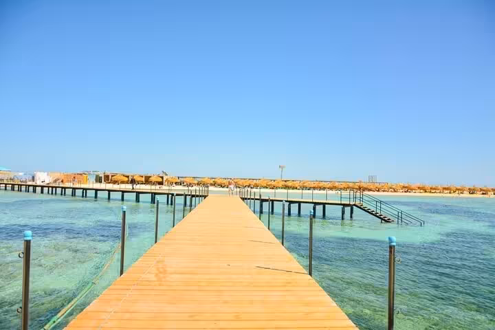 Wooden pier over turquoise Red Sea at Utopia Bianca Island, Hurghada day trip with transfer and lunch