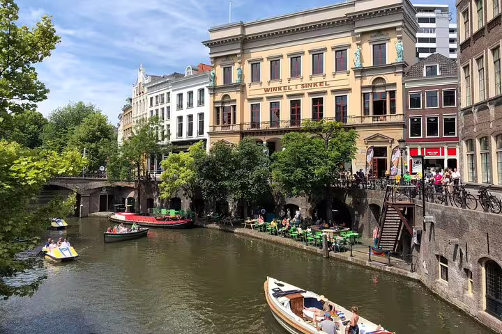 Utrecht Oudegracht canal with boats and terraces by Winkel van Sinkel, highlight of a private city tour
