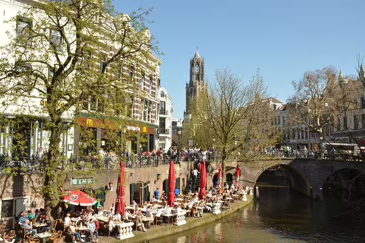 Sunny Utrecht Oudegracht terrace cafes by the canal, perfect stop on a self-guided e-scavenger hunt tour