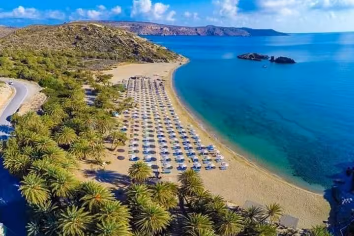 Aerial view of Vai Palm Beach, Crete with sunbeds and turquoise sea on a 7-day private tour from Heraklion