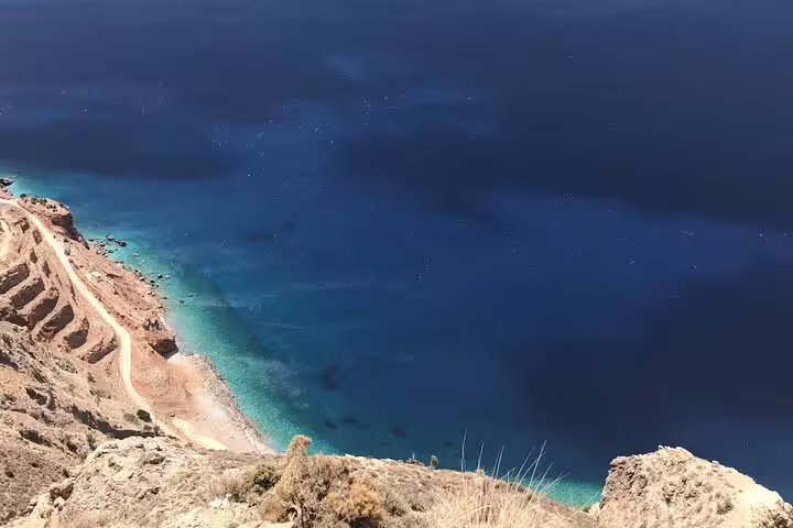 Breathtaking aerial view of turquoise waters and rugged coastline on the North Coast Adventure Tour.