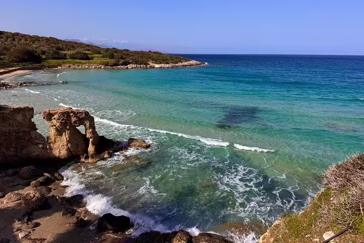 Scenic view of the turquoise sea and rocky coastline on the Palm Forest of Vai tour, showcasing Crete's natural beauty.