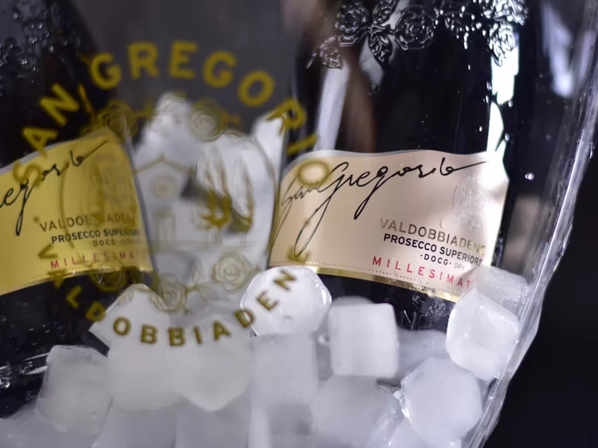 Chilled bottles of premium Valdobbiadene Prosecco in an ice bucket, perfect for a countryside winery tour.