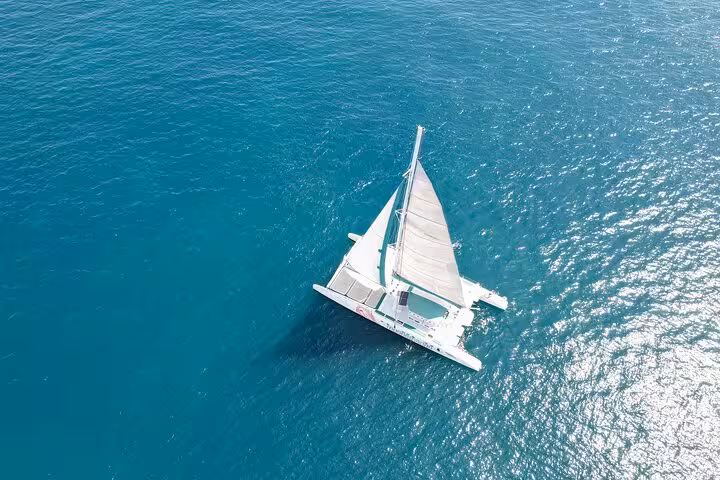 Aerial view of catamaran sailing on turquoise Mediterranean Sea, Valencia catamaran cruise tour