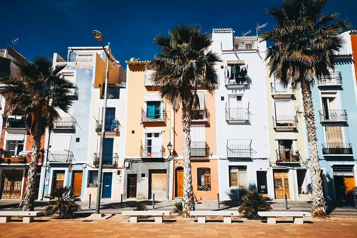 Pastel Valencia seaside buildings and palm trees on an e-bike tour route to beaches and city highlights