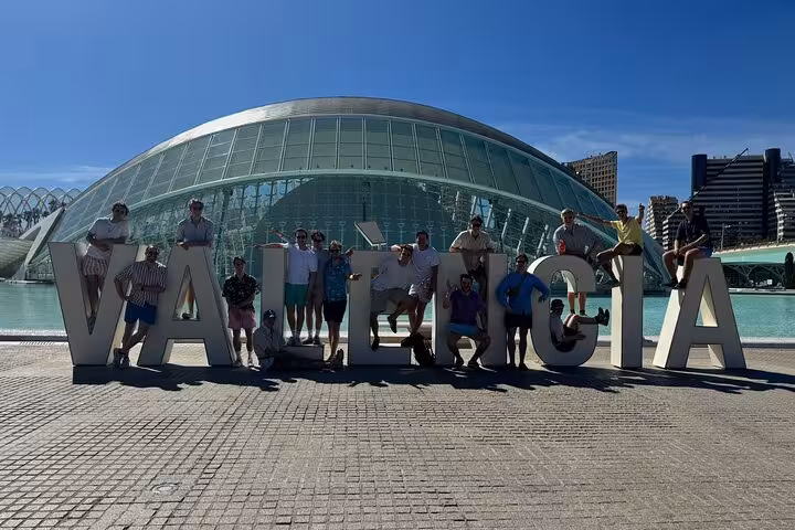 Tour group posing at Valencia sign in City of Arts and Sciences on Valencia e-bike tour plus catamaran cruise