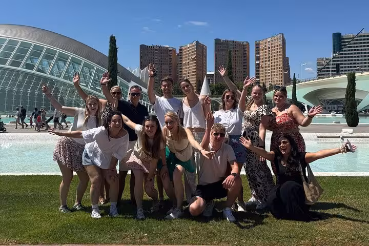 Happy travelers at Valencia City of Arts and Sciences during all-in-one e-bike tour of beaches, old town and arts
