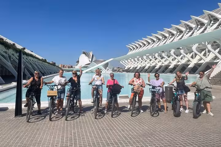 E-bike tour group at Valencia City of Arts and Sciences, cycling old town and beach route by e-bike