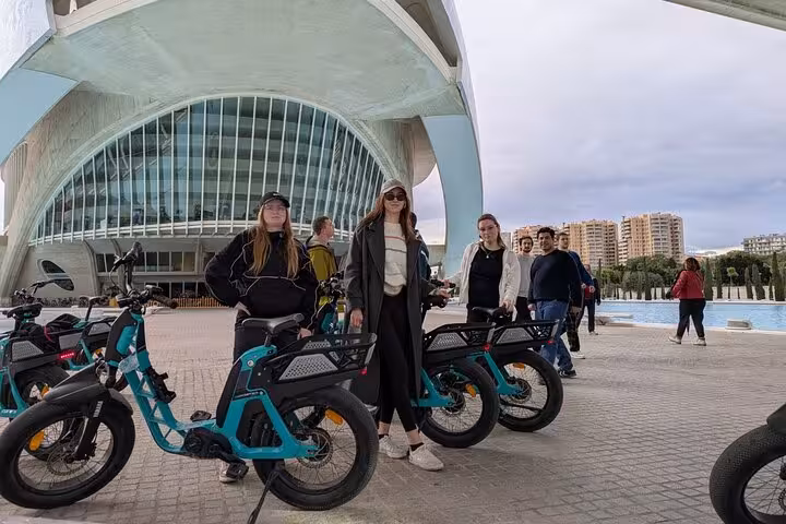 Group with rental e-bikes at Valencia City of Arts and Sciences, guided e-bike tour before catamaran cruise
