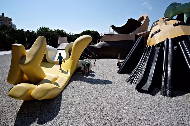 Children play on the giant Gulliver sculpture in Valencia's park, perfect for family fun during a private city tour.