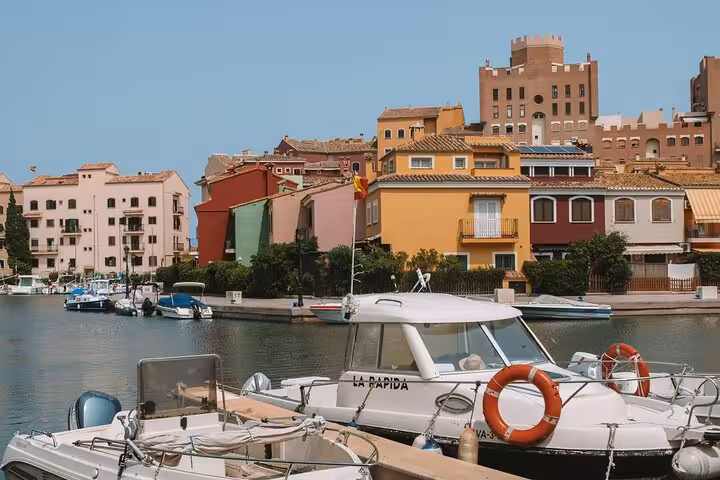 Valencia marina waterfront with boats and colorful houses, scenic stop on beaches and city e-bike tour