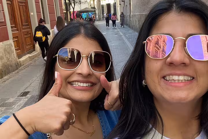 Two travelers selfie on Valencia Iconic Sights scavenger hunt, exploring Old Town streets near Plaza de la Reina