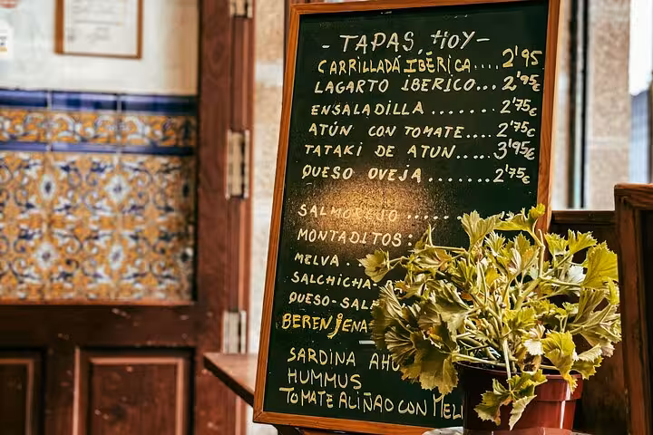 Chalkboard tapas menu in a traditional Valencia bar, featured stop on the gourmet tapas tour by bike or on foot