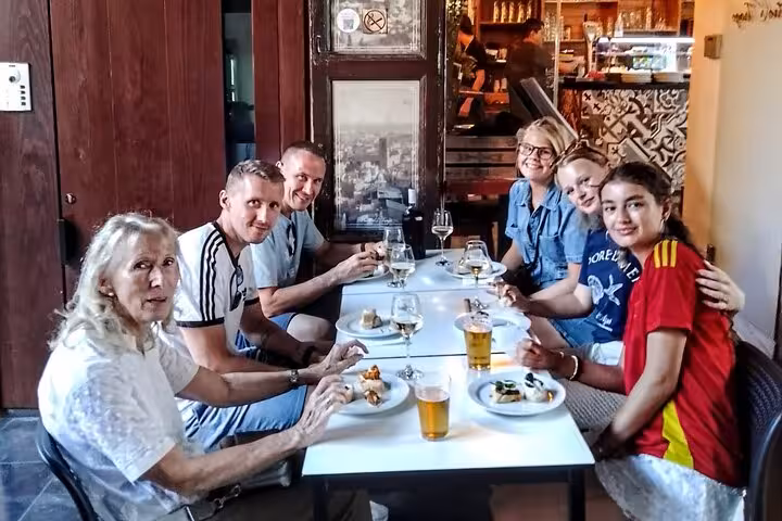 Group enjoying tapas and local beer at a Valencia bar stop on the gourmet tapas tour by bike or on foot