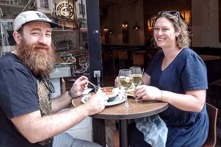 Guests enjoy tapas and local wine at a Valencia bar stop on the gourmet tapas tour by bike or on foot