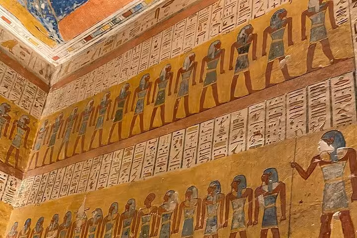 Colorful ancient Egyptian frescoes depicting figures and hieroglyphics in the Valley of the Kings, Luxor West Bank.