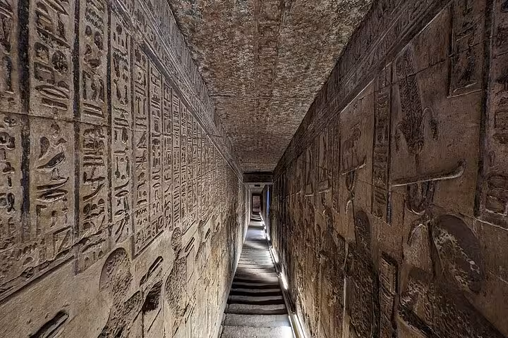 Intricate hieroglyphics adorn the walls of a narrow corridor in the Valley of the Kings, a highlight of Luxor's West Bank tour.