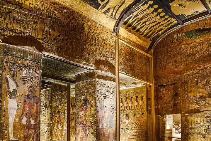 Golden tomb wall hieroglyphs in Valley of the Kings, Luxor on private Cairo to Luxor flight day tour