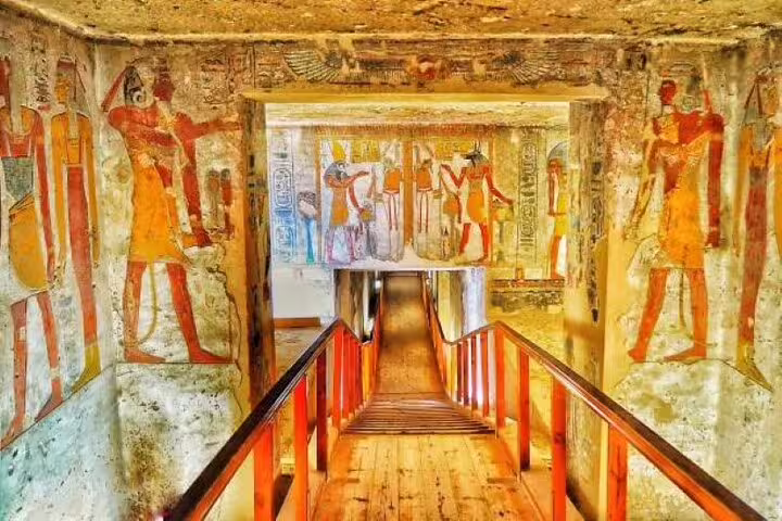 Painted tomb corridor in Valley of the Kings, Luxor, on day tour with ancient Egyptian murals
