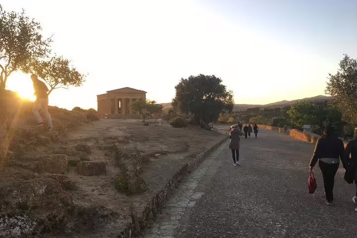 Sunset walk to a Greek temple in Valley of the Temples, Agrigento on a guided group tour from Palermo