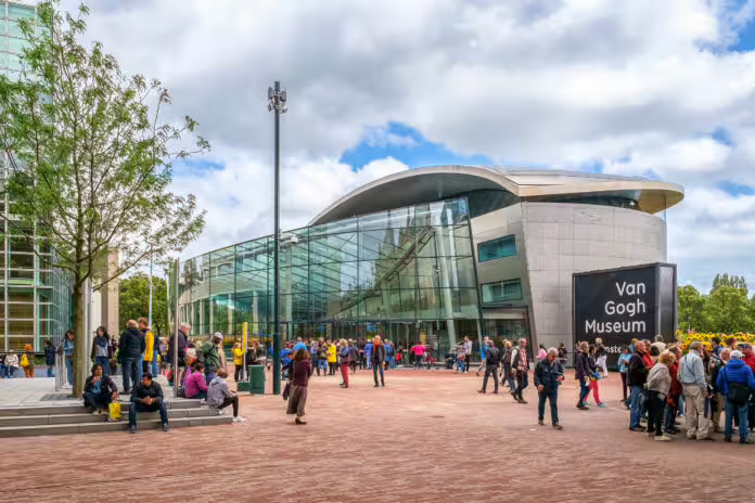 Visitors gather outside the modern Van Gogh Museum in Amsterdam, ready to explore famous artworks on a guided tour.