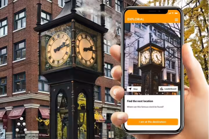 Steam Clock in Vancouver Gastown with scavenger hunt app on phone, showing clues for a self-guided walking tour