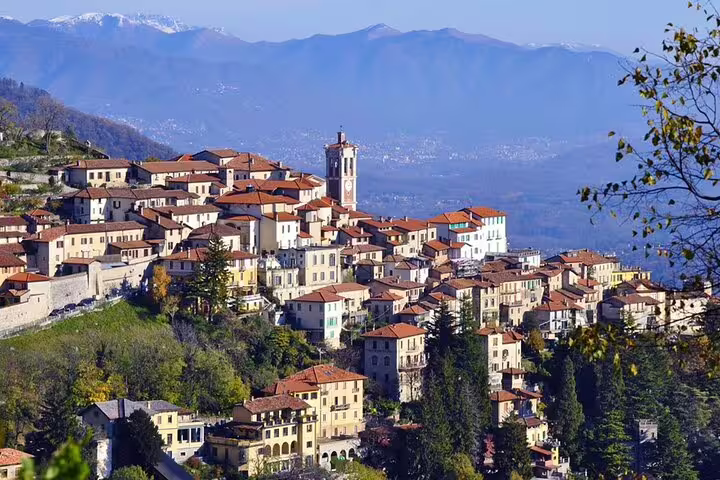 Scenic view of Varese's charming hillside town with historic architecture and lush greenery, perfect for a customizable private tour.
