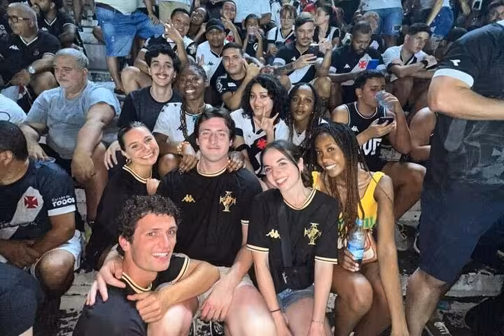 Fans and tour guests cheering together in Vasco da Gama section at São Januário, Rio de Janeiro soccer game