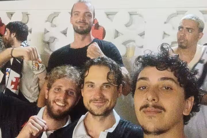 Group selfie with Vasco da Gama supporters in Rio de Janeiro before match, joining local guide soccer tour