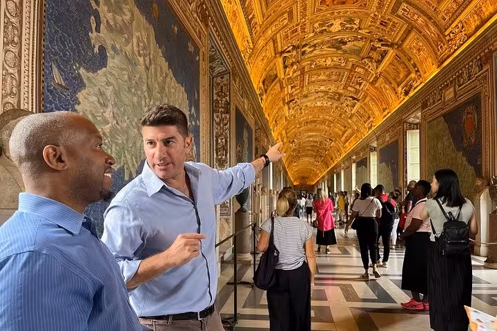 Tourists explore the ornate Gallery of Maps in the Vatican Museum during a private guided tour.