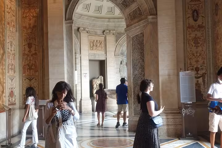 Visitors explore ornate hallways of the Vatican Museum, capturing the essence of a guided tour experience.
