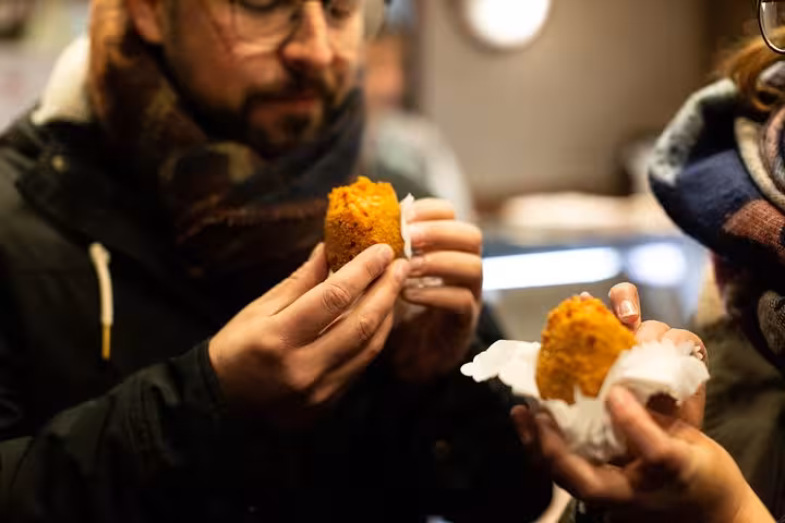 Tourists enjoy traditional Italian street food during the Pope's favorite food tour in the Vatican area of Rome.