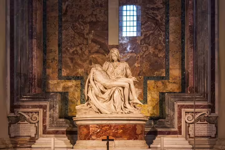 Guided Vatican tour guests viewing Michelangelo’s Pietà marble sculpture inside St Peter’s Basilica near the Sistine Chapel