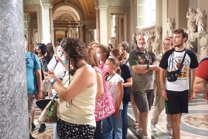 Visitors explore the Vatican Museum's ornate halls on a fast track guided tour to the Sistine Chapel.