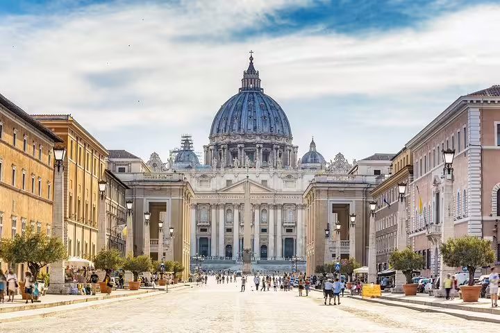 Visitors walk along the grand avenue leading to St Peter’s Basilica on a Vatican Museums and Sistine Chapel guided tour