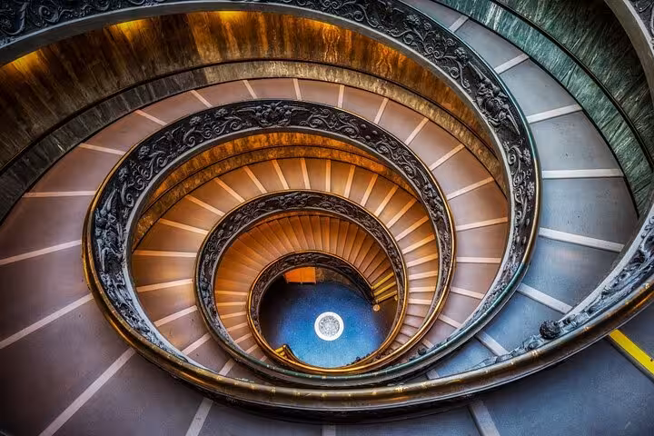 Spiral staircase in Vatican Museums, showcasing intricate architecture on the Colosseum and Vatican tour.