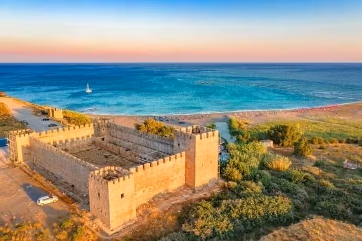 Venetian fortress by the sea at sunset in Crete, a highlight of a 7-day private guided tour from Heraklion