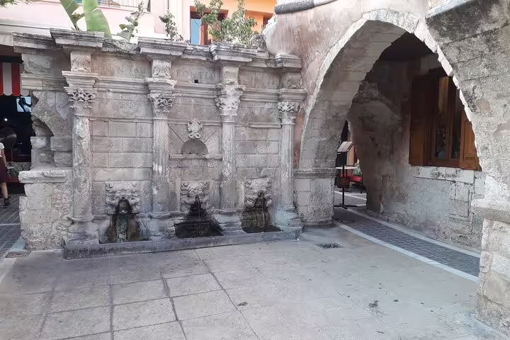 Historic Venetian fountain in Rethymno, Crete, showcasing intricate stonework, part of a private tour including Chania and Kournas Lake.