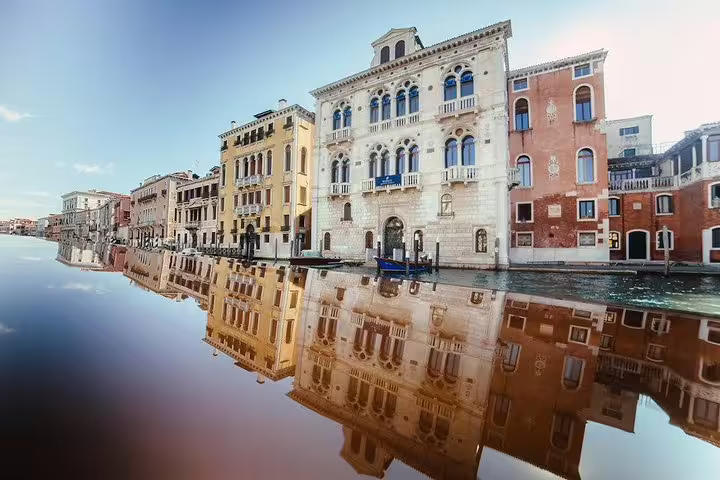 Scenic view of elegant Venetian buildings reflecting on the Grand Canal, perfect for a private boat tour.