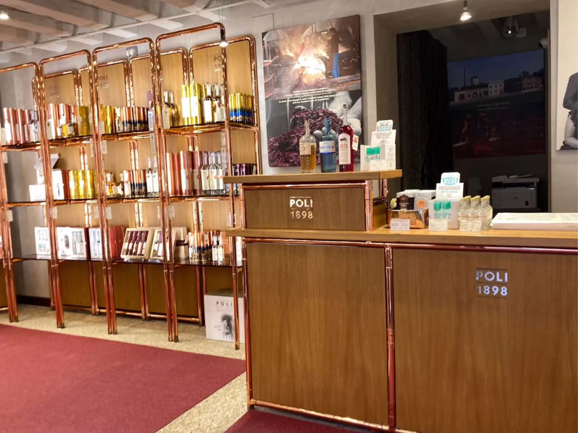 Interior of a Venetian grappa tasting room with polished wood counters and a wide selection of premium spirits.