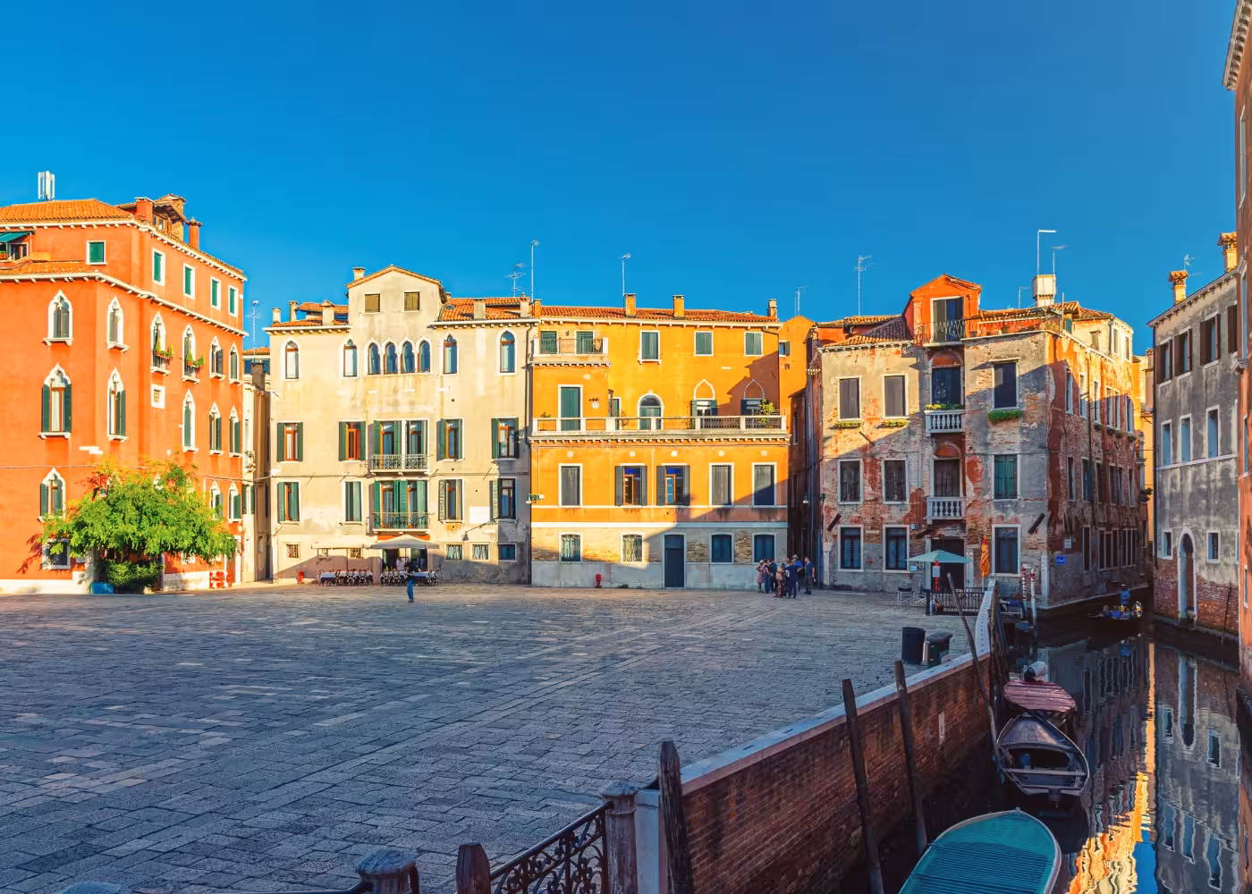 Charming Venetian square with colorful historic buildings on the San Marco to Rialto walk tour.