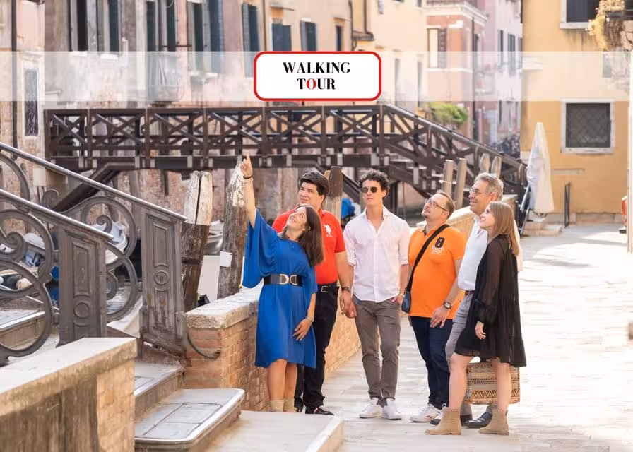 Group of tourists exploring a charming Venetian street during an off-the-beaten-path walking tour.