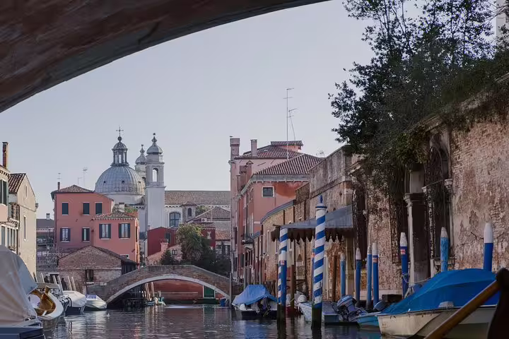Scenic Venice canal view with historic architecture and charming bridge on deluxe heritage tour.