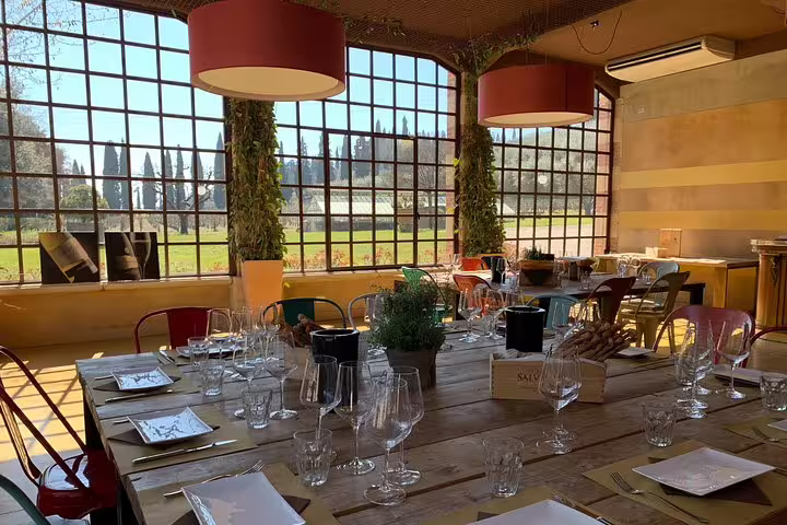 Elegant dining setup in a sunlit room with garden views, perfect for a stop during private transfers from Venice to Florence.