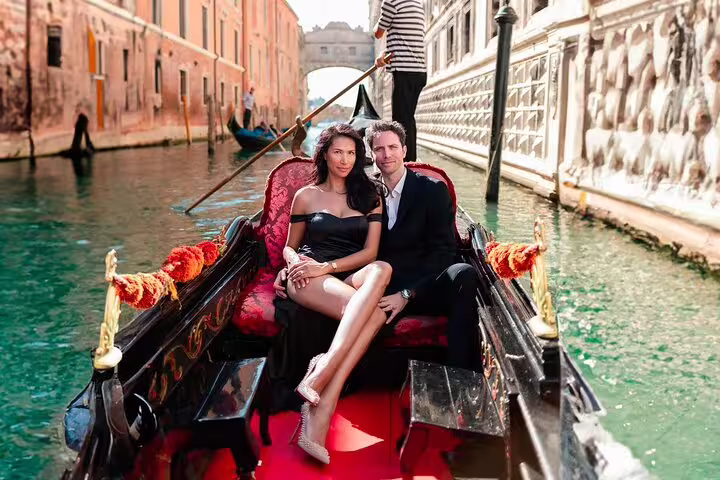 Venice gondola couple portrait session on Grand Canal, elegant couple seated for romantic photoshoot