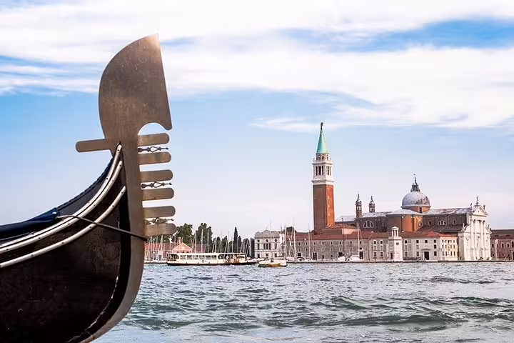 Discover Venice from a gondola on the Grand Canal with views of San Giorgio Maggiore and its stunning architecture.